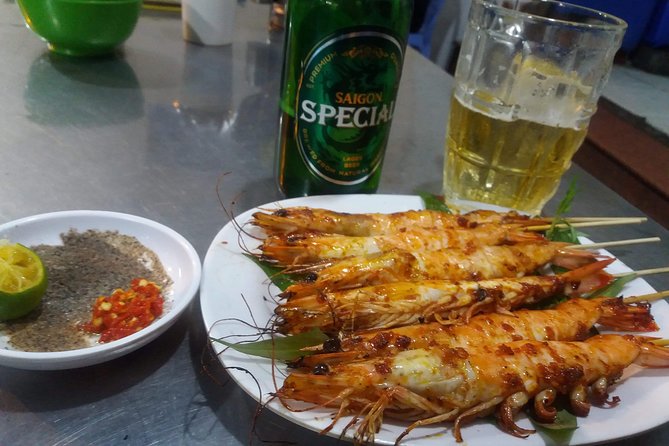 Saigon After Dark and Street Food by Motorbike and Scooter - Flowers, fashion, and the ride through District 5